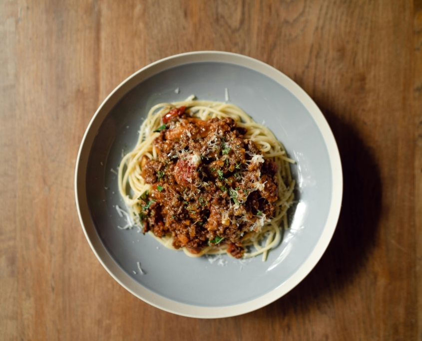 pexels-ketut-subiyanto-4349774 Pasta Bolognese in a bowl on a wooden table.